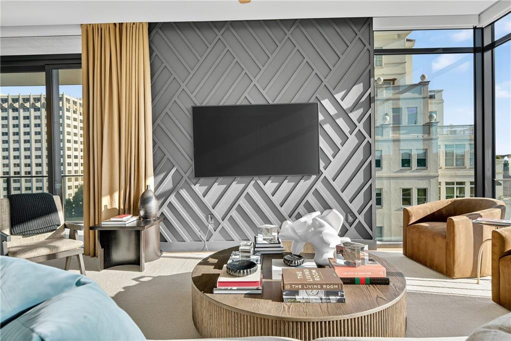 2520 Peachtree Road Northwest, Unit 903 Atlanta, GA 30305 - Photo 2 of 62 a living room with furniture a flat screen tv and a fireplace