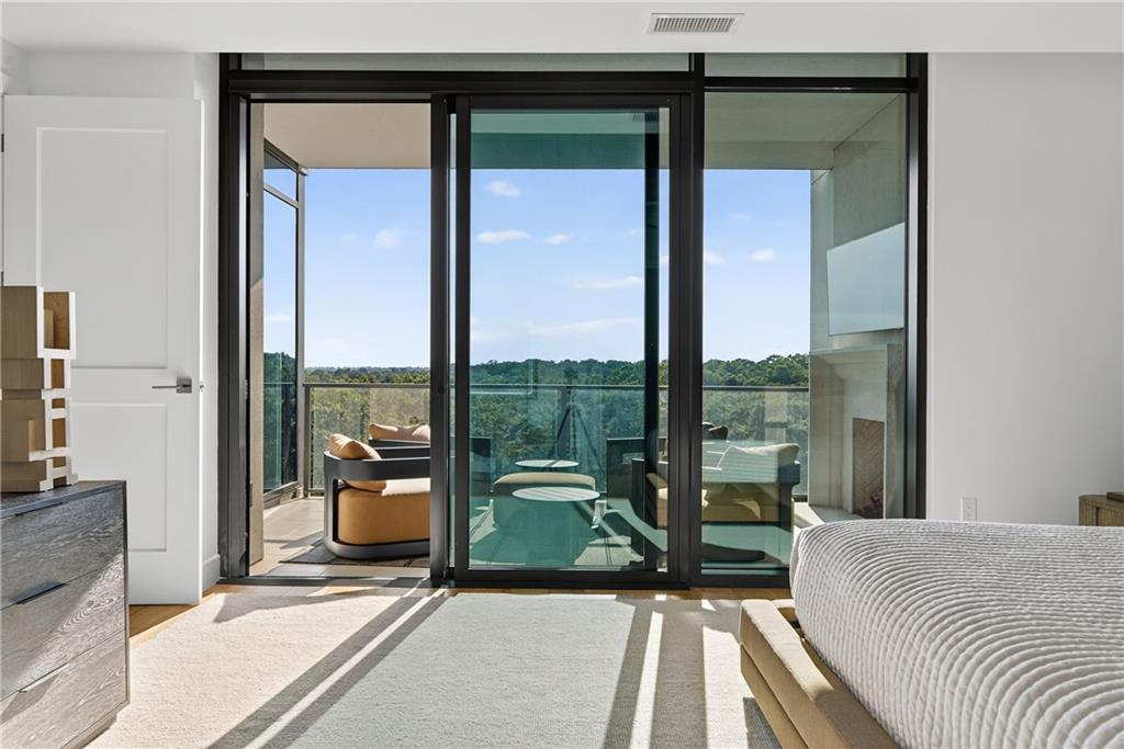 2520 Peachtree Road Northwest, Unit 903 Atlanta, GA 30305 - Photo 23 of 62 a bedroom with a bed and glass door