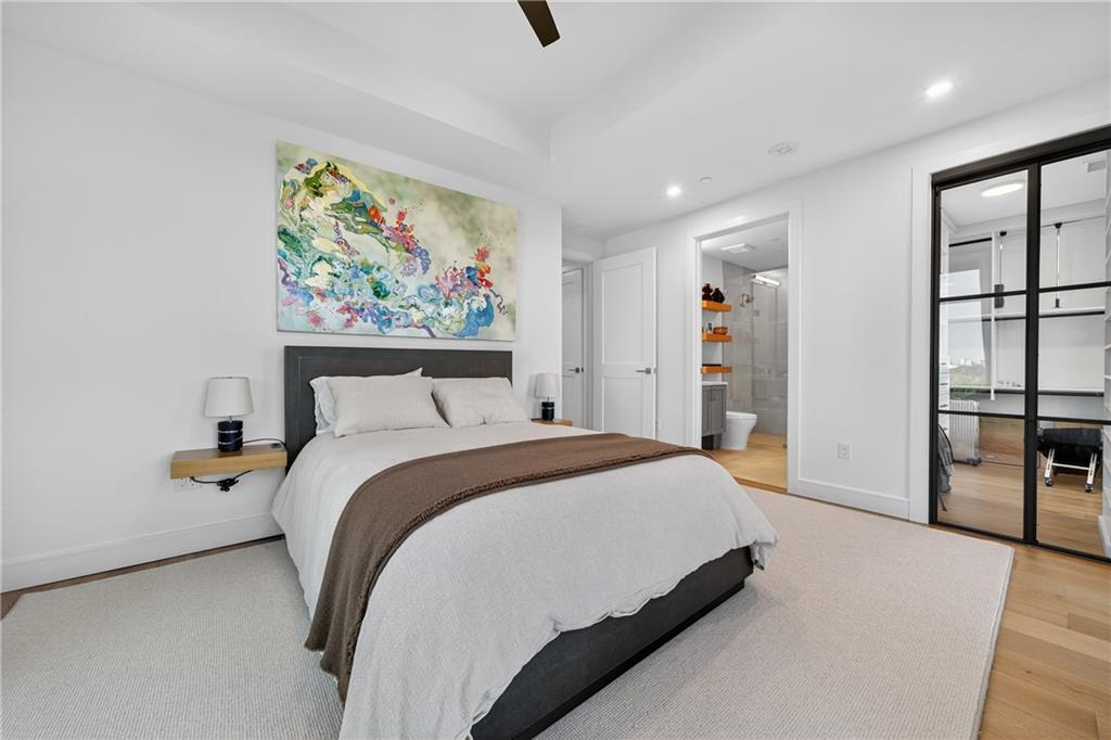 2520 Peachtree Road Northwest, Unit 903 Atlanta, GA 30305 - Photo 31 of 62 a spacious bedroom with a bed painting on the wall and a window