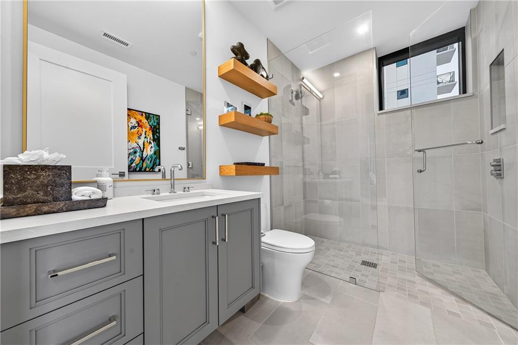 2520 Peachtree Road Northwest, Unit 903 Atlanta, GA 30305 - Photo 34 of 62 a bathroom with a sink a toilet and shower