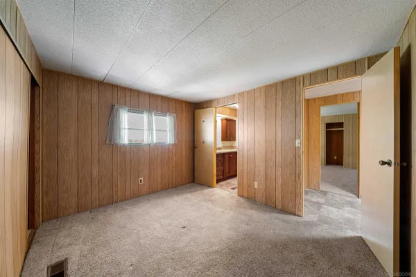 an empty room with windows and closet