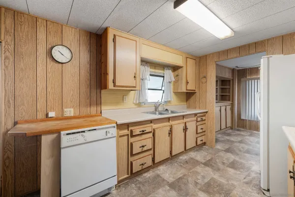 a kitchen with sink cabinets and stove