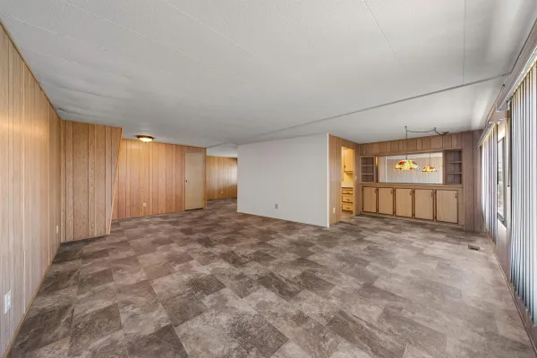 a view of an empty room with window and cabinet