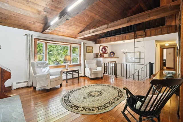 a view of a livingroom with furniture and a dining table