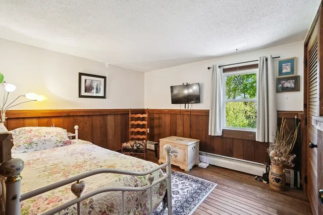 a bedroom with a bed and a flat tv screen