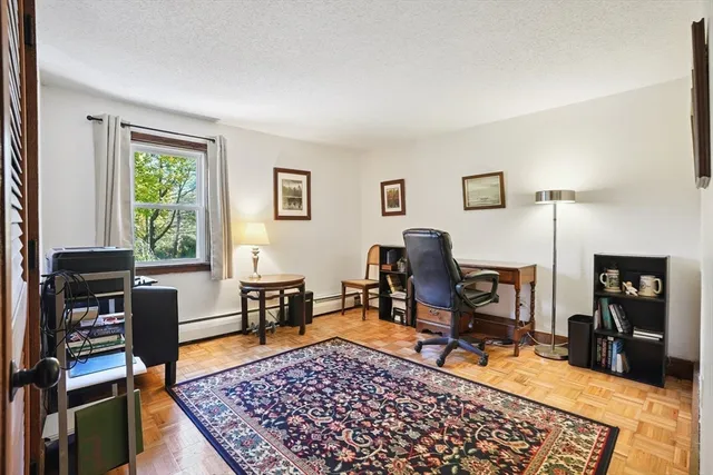 a living room with furniture a rug and a window