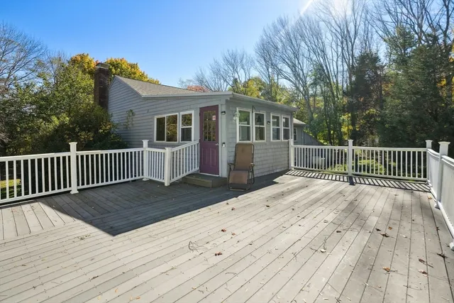 a view of backyard with a deck and wooden floor
