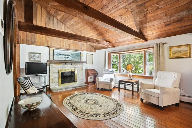 a living room with furniture a fireplace and a table