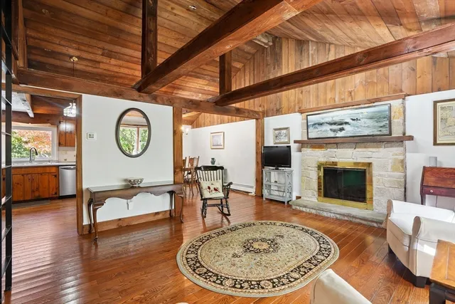 a living room with furniture a clock and a fireplace