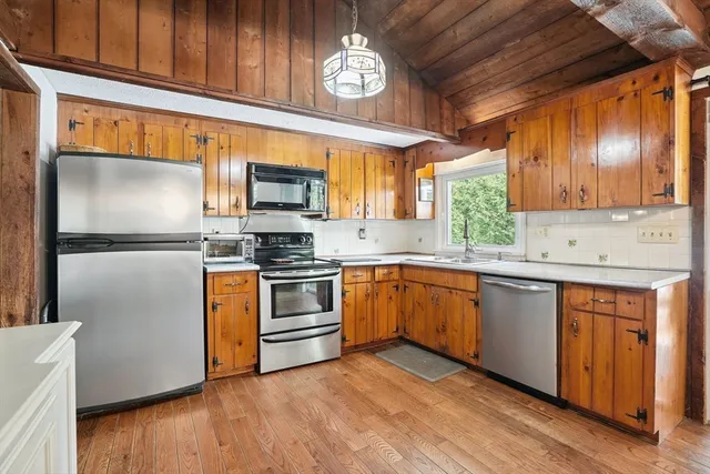 a kitchen with granite countertop stainless steel appliances and wooden cabinets