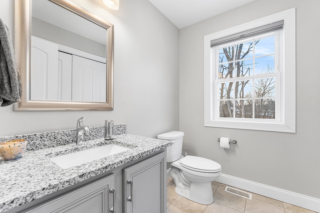 29 Dawley Road Westminster, MA 01473 - Photo 11 of 30 a bathroom with a granite countertop sink a toilet and a window