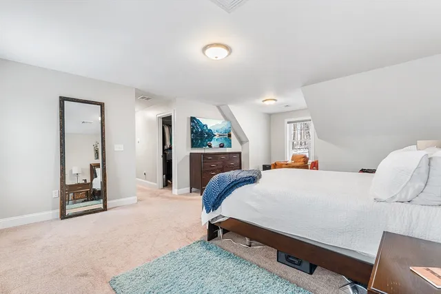 a bedroom with a bed and large mirror