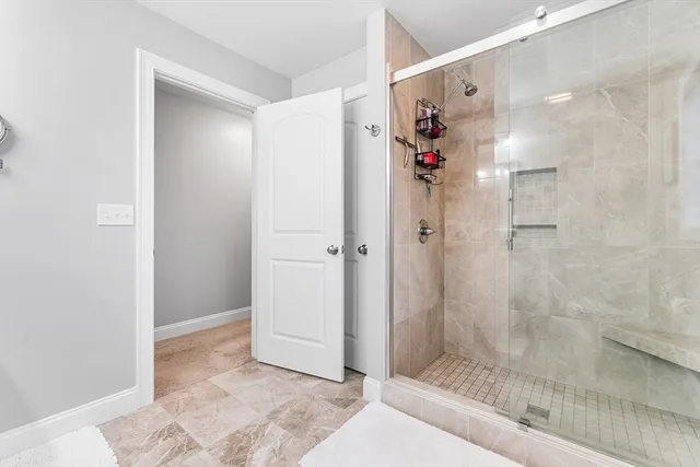 a bathroom with a shower and a sink