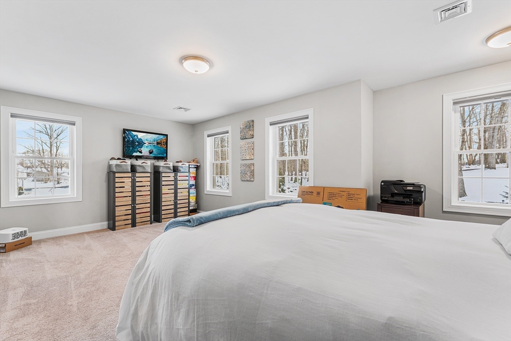 29 Dawley Road Westminster, MA 01473 - Photo 18 of 30 a large bed sitting in a spacious bedroom next to a window and a flat screen tv