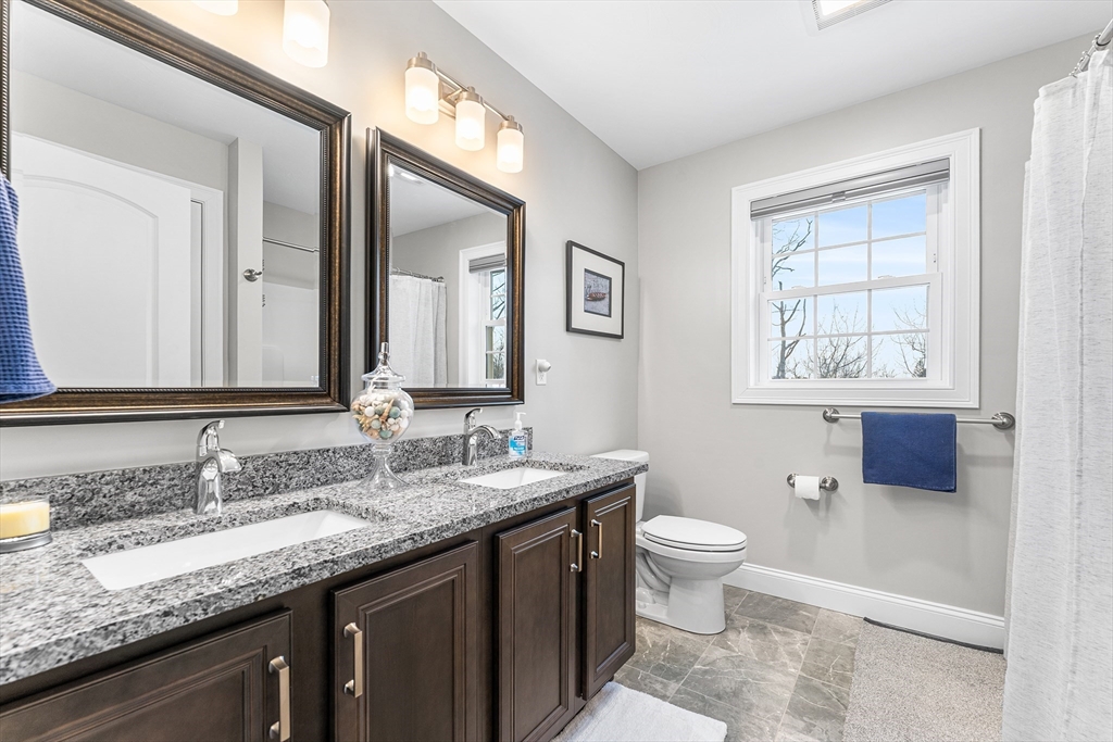 29 Dawley Road Westminster, MA 01473 - Photo 22 of 30 a bathroom with a granite countertop sink a large mirror a toilet and a window