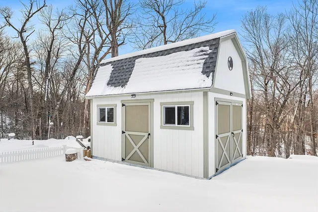 a view of white house with a snow on the road