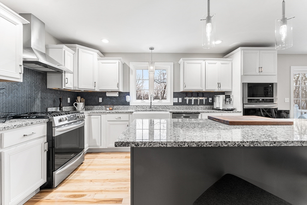 29 Dawley Road Westminster, MA 01473 - Photo 4 of 30 a kitchen with stainless steel appliances granite countertop a stove a sink and a microwave