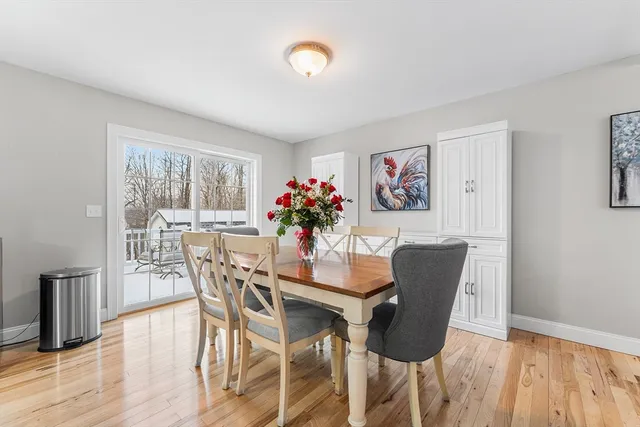 a dining room with furniture and wooden floor