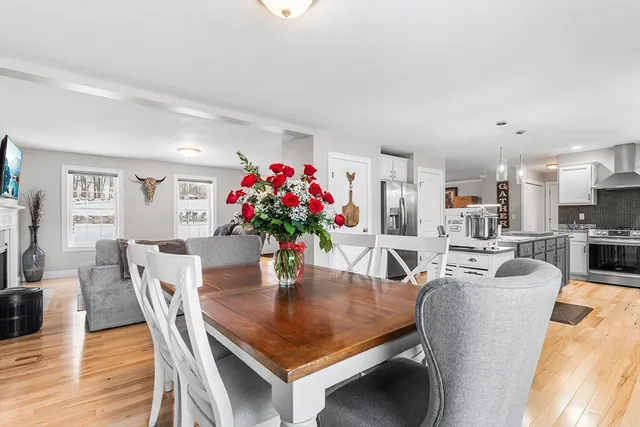 a dining room with furniture and wooden floor