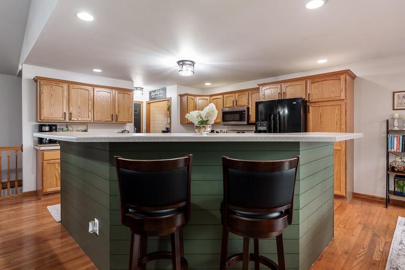 320 Lake Lida Lane Rochelle, IL 61068 - Photo 12 of 43 a kitchen with stainless steel appliances granite countertop wooden cabinets and a refrigerator