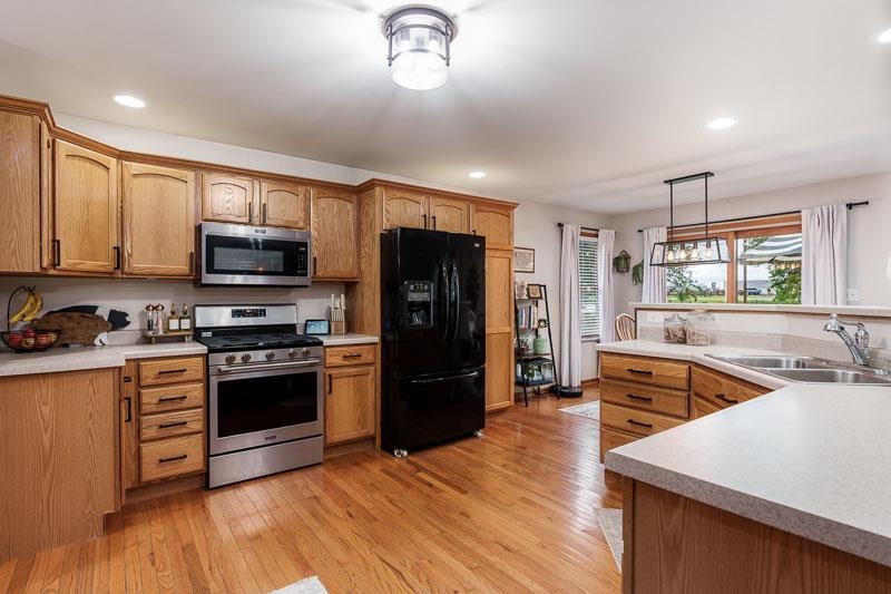 320 Lake Lida Lane Rochelle, IL 61068 - Photo 13 of 43 a kitchen with stainless steel appliances granite countertop a refrigerator stove top oven and sink