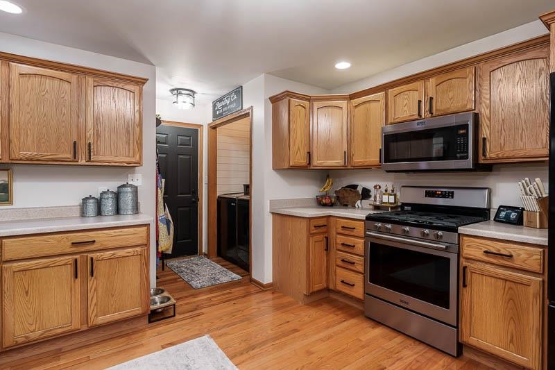 320 Lake Lida Lane Rochelle, IL 61068 - Photo 15 of 43 a kitchen with granite countertop wooden cabinets stainless steel appliances and a window