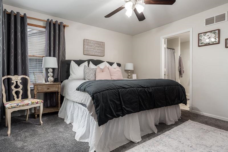 320 Lake Lida Lane Rochelle, IL 61068 - Photo 20 of 43 a bedroom with a bed and a chandelier