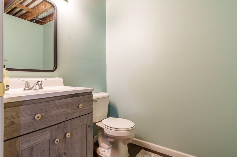 320 Lake Lida Lane Rochelle, IL 61068 - Photo 35 of 43 a bathroom with a granite countertop toilet a sink and a mirror