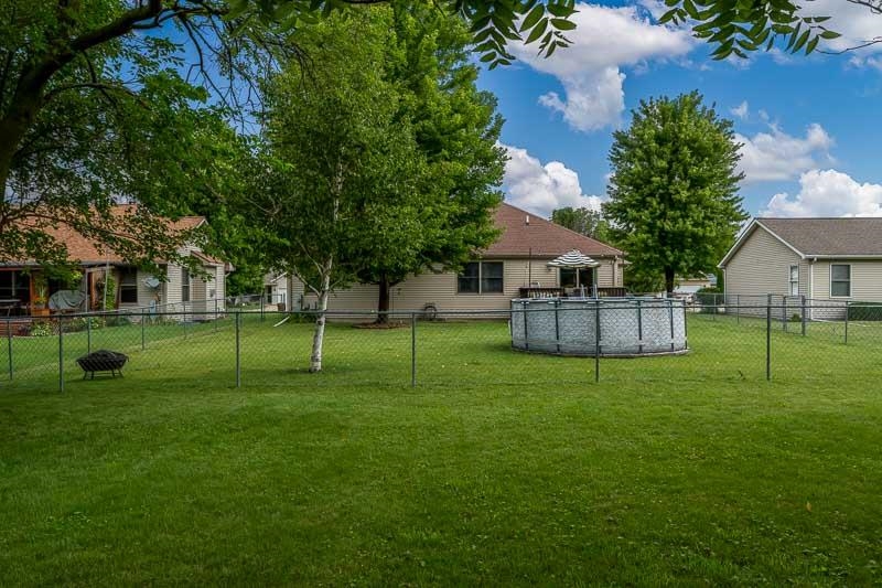 320 Lake Lida Lane Rochelle, IL 61068 - Photo 41 of 43 a view of a house with a big yard and potted plants and large trees