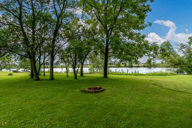 320 Lake Lida Lane Rochelle, IL 61068 - Photo 42 of 43 a view of pool and trees in the background