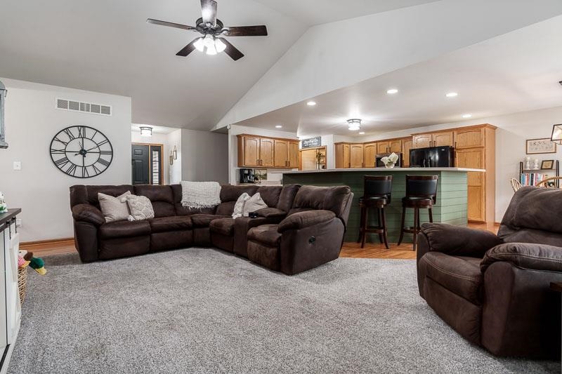 320 Lake Lida Lane Rochelle, IL 61068 - Photo 8 of 43 a living room with furniture a clock and a ceiling fan