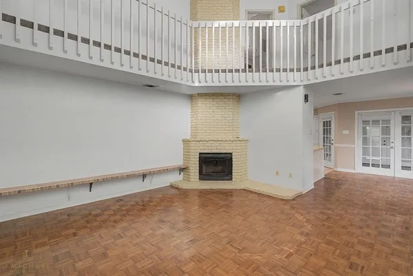 a view of an empty room with a fireplace