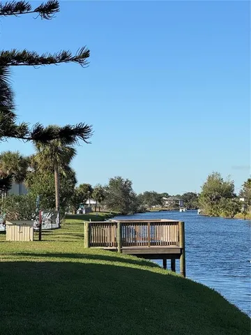an aerial view of a house with a garden and lake view