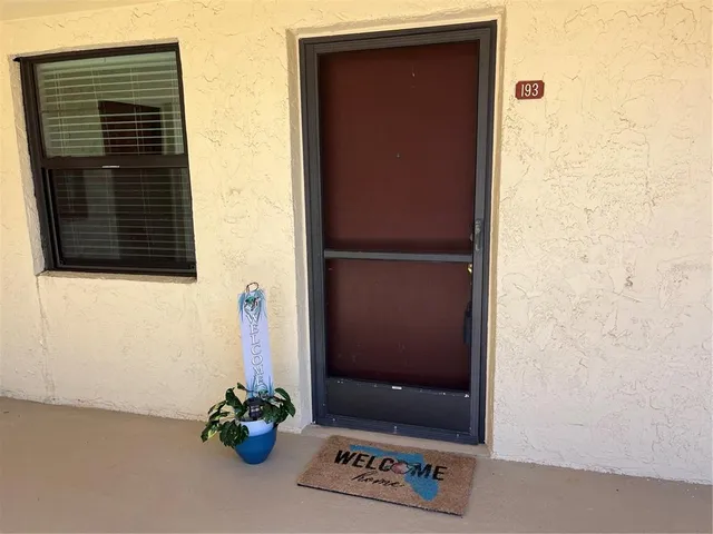 a living room with furniture and a lamp