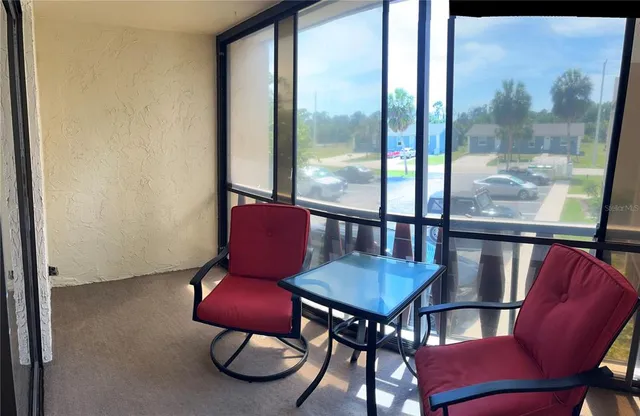 a view of a dining room with furniture window and outside view