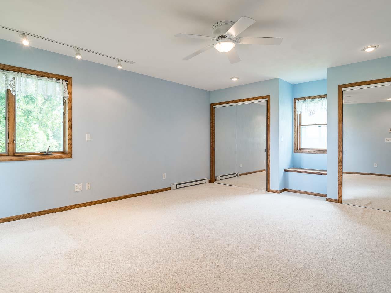 10208 Center Road Durand, IL 61024 - Photo 17 of 25 an empty room with chandelier fan and windows