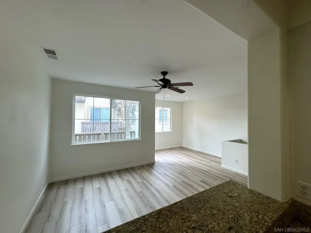 a view of an empty room and a window