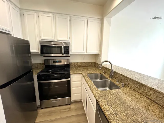 a kitchen with a sink stove and refrigerator