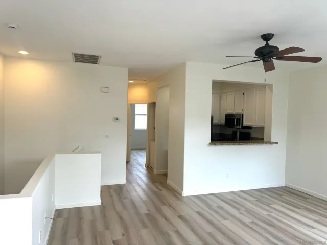 a view of empty room with wooden floor