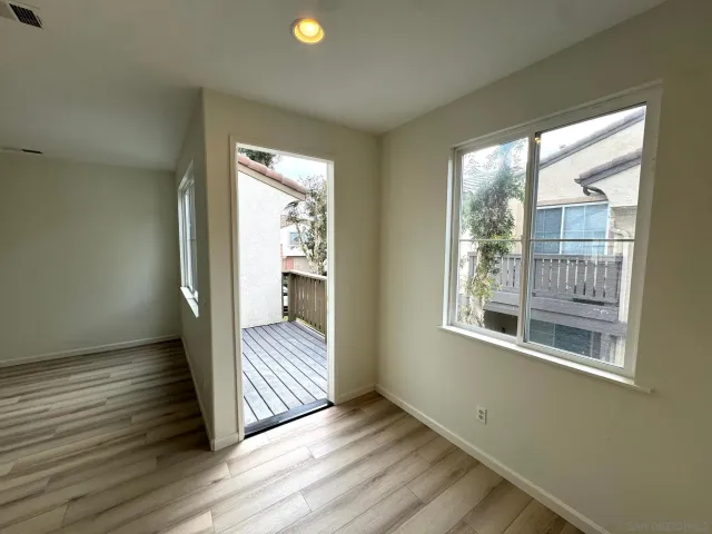 a view of a room with wooden floor and balcony