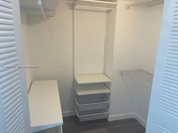 a view of hallway with stairs and wooden floor