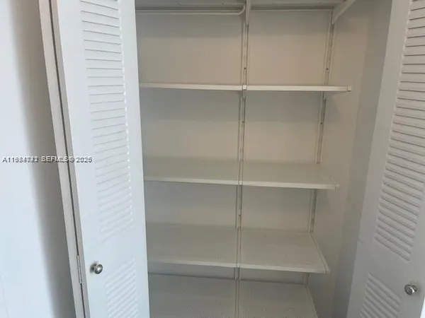 a hallway with furniture and a chandelier