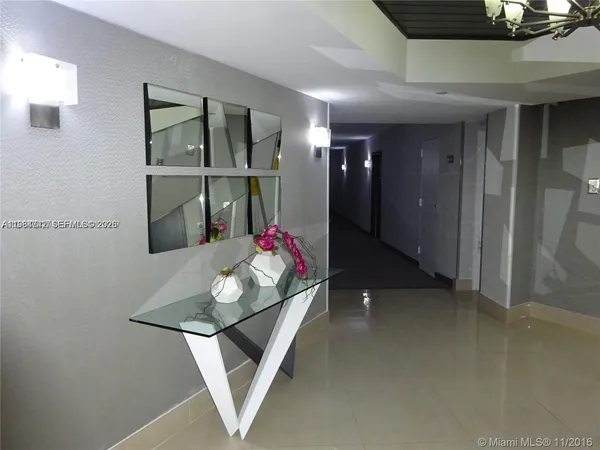 a front view of a building with a tree