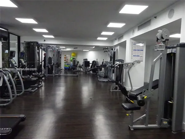 a view of building with lake view and tall trees