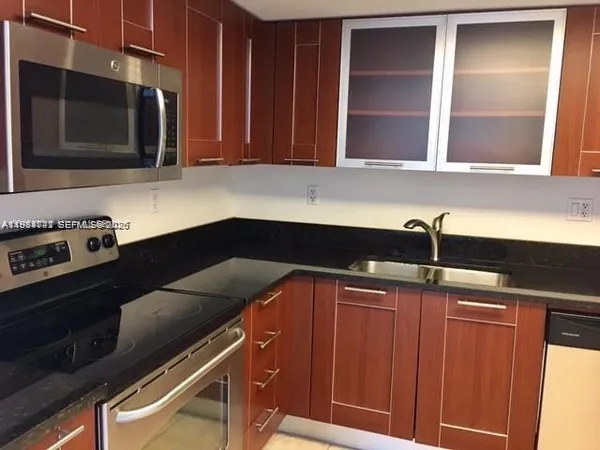 a kitchen with a sink and cabinets