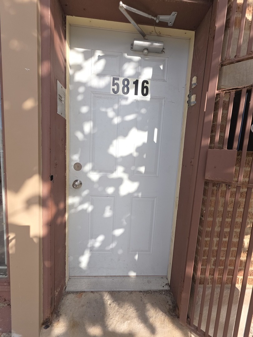 5816 West Chicago Avenue, Unit 2 Chicago, IL 60651 - Photo 2 of 10 a view of a glass door