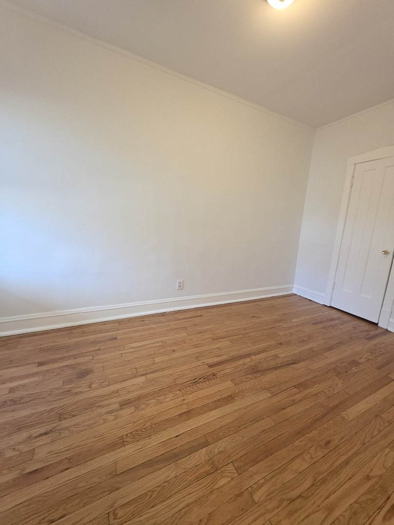 5816 West Chicago Avenue, Unit 2 Chicago, IL 60651 - Photo 7 of 10 a view of an empty room with wooden floor