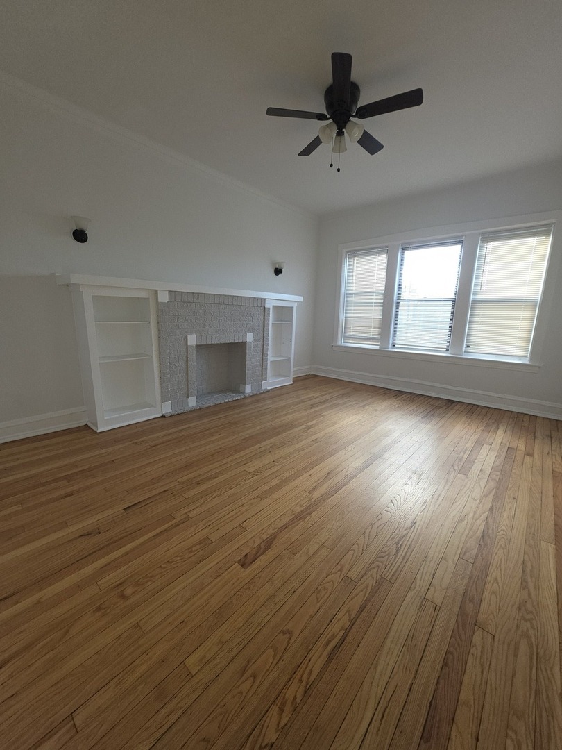 5816 West Chicago Avenue, Unit 2 Chicago, IL 60651 - Photo 10 of 10 a view of empty room with wooden floor and fan
