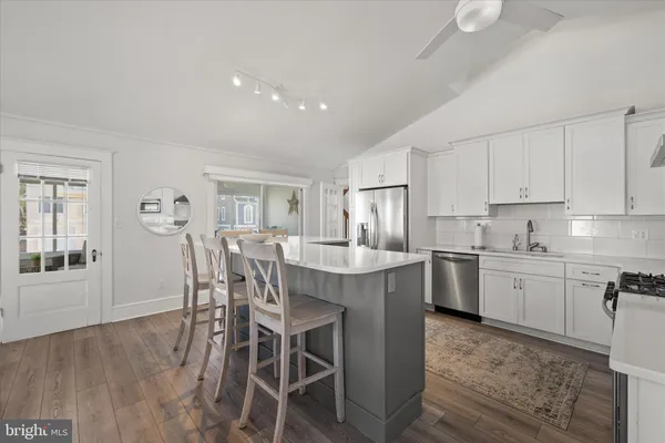 a kitchen with stainless steel appliances a stove sink and cabinets