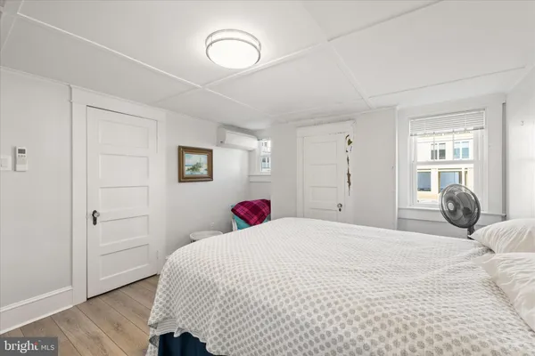 a bedroom with a bed and a couch